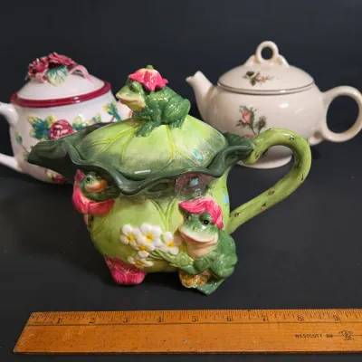 LOT 47: Whimsical Frog Teapot, Harry and David Limited Edition White W/ Raised Red Roses Floral Ceramic Teapot, and Ceramic Teapot from...