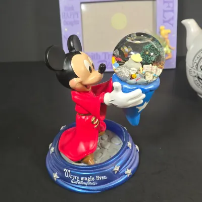 LOT 97: Sorcerer Mickey Mouse "Where Magic Lives" Snow Globe Figurine, Cinderella Wallet, Teapot for One Set, Picture Frame,...