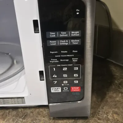 LOT 94: Toshiba Countertop Microwave Oven with a Stainless Steel Finish