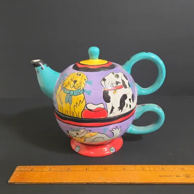LOT 41: Vintage Novelty Teapot by MSRF Inc. Design Studio and Dogzilla Hand-Painted Ceramic Stackable Teapot and Cup Set