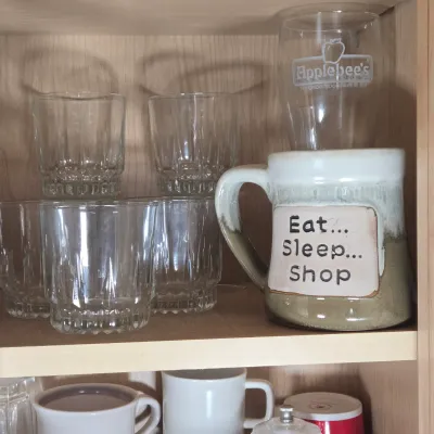 LOT 102: Kitchen Cabinet Lot Including Drinking Glasses. Philadelphia Eagles Mug, Miller Lite Mug, and More