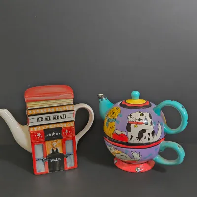 LOT 41: Vintage Novelty Teapot by MSRF Inc. Design Studio and Dogzilla Hand-Painted Ceramic Stackable Teapot and Cup Set
