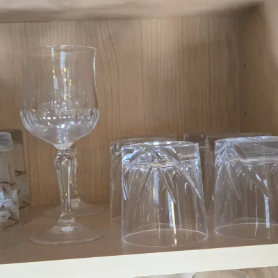 LOT 101: Kitchen Cabinet Lot Including Wine Glasses, Trifle Bowl, and More