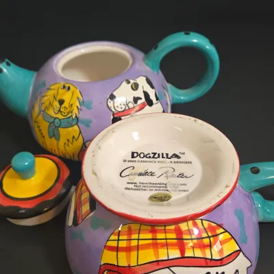 LOT 41: Vintage Novelty Teapot by MSRF Inc. Design Studio and Dogzilla Hand-Painted Ceramic Stackable Teapot and Cup Set