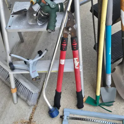 LOT 57: Garage Finds/ Step Ladders, Rakes, Shovels, Sprinklers, and More
