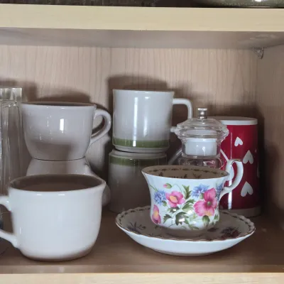 LOT 102: Kitchen Cabinet Lot Including Drinking Glasses. Philadelphia Eagles Mug, Miller Lite Mug, and More