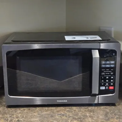 LOT 94: Toshiba Countertop Microwave Oven with a Stainless Steel Finish