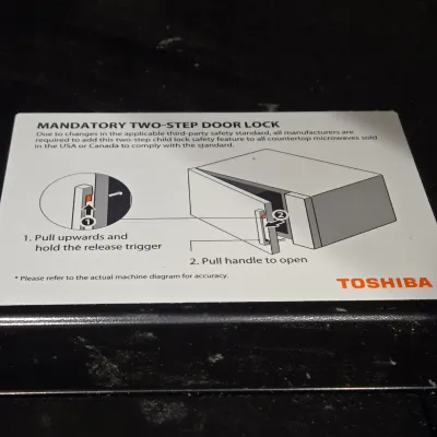 LOT 94: Toshiba Countertop Microwave Oven with a Stainless Steel Finish