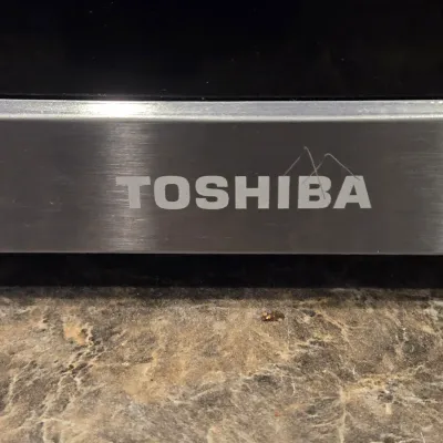 LOT 94: Toshiba Countertop Microwave Oven with a Stainless Steel Finish