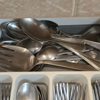 LOT 86: Multiple Kitchen Drawers Lot Including Flatware, Utensils, and More