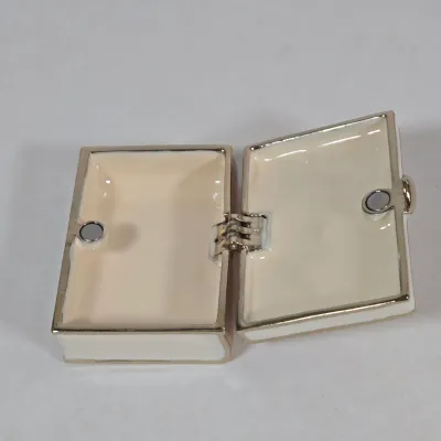 LOT 100: Porcelain Trinket Boxes, Two Clear, Geometric Cut Glass Paperweights, and More