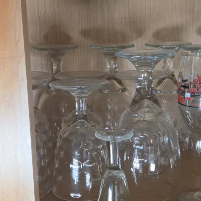 LOT 101: Kitchen Cabinet Lot Including Wine Glasses, Trifle Bowl, and More