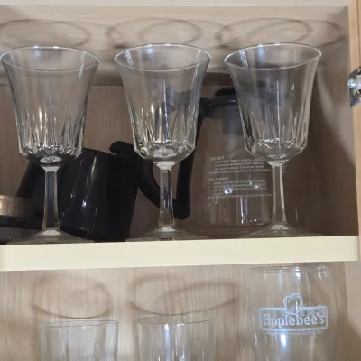 LOT 102: Kitchen Cabinet Lot Including Drinking Glasses. Philadelphia Eagles Mug, Miller Lite Mug, and More