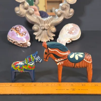 LOT 85: Ornate Wall Mirror, Handmade Hanging Ornament, Clear Glass Dragon & Turtle, Miniature Ceramic Dog, 2 Traditional Wooden Dala...