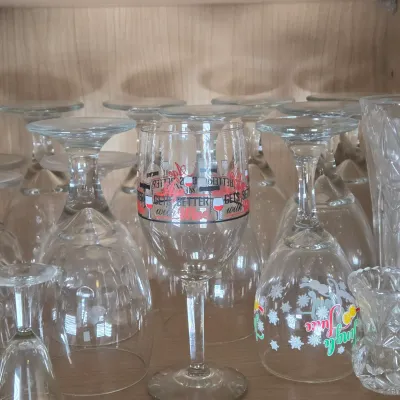 LOT 101: Kitchen Cabinet Lot Including Wine Glasses, Trifle Bowl, and More