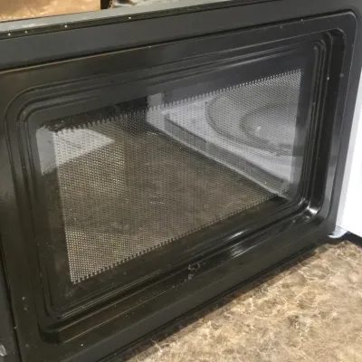 LOT 94: Toshiba Countertop Microwave Oven with a Stainless Steel Finish