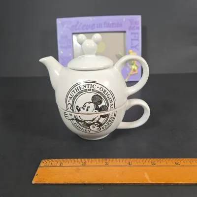 LOT 97: Sorcerer Mickey Mouse "Where Magic Lives" Snow Globe Figurine, Cinderella Wallet, Teapot for One Set, Picture Frame,...