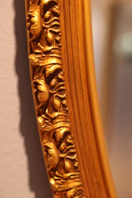 Ornate Gold Framed Oval Wall Mirror with Floral Scroll Detail