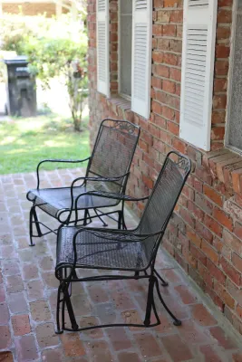Pair of Vintage Wrought Iron Mesh Patio Glider Chairs