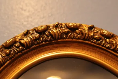Ornate Gold Framed Oval Wall Mirror with Floral Scroll Detail