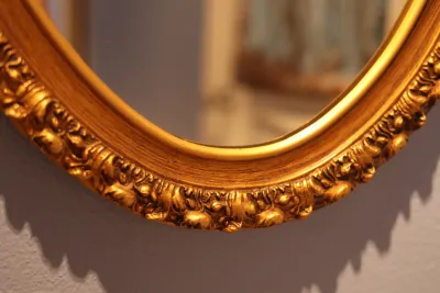 Ornate Gold Framed Oval Wall Mirror with Floral Scroll Detail