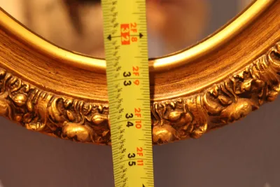 Ornate Gold Framed Oval Wall Mirror with Floral Scroll Detail