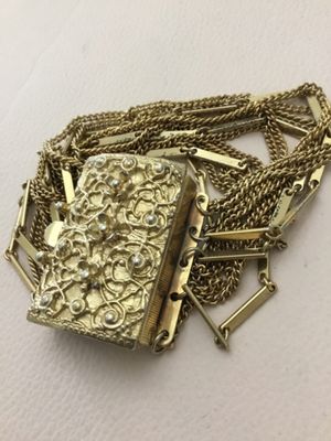 Vintage multi strand, gold tone bracelet, featuring intricate open work, rectangular, sliding centerpiece, class decorated with raised...