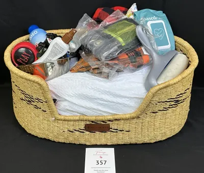 Woven, natural fiber pet bed basket filled with pet care supplies and grooming tools