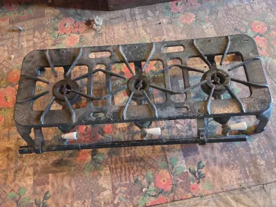Vintage cast-iron three-burner camp stove with porcelain handles marked 137 on bottom Possibly a Griswold?
