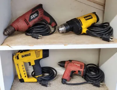 DEWALT MULTI-TRACKER & HAMMER DRILL, A SKIL HAMMER DRILL, AND A HILTI SD 4500 DRYWALL SCREWDRIVER