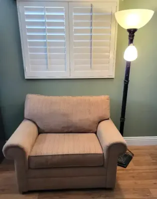 OVERSIZED TAN ARMCHAIR WITH TALL FLOOR LAMP