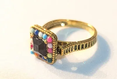**NEW ARRIVAL** SIZE 10 RING Featuring a BLACK Tone Center Stone. Surrounded by Small Round MULTICOLOR Beads. Design Extends to the...