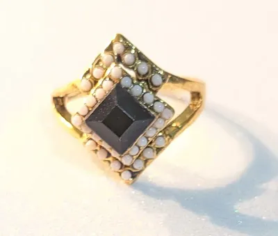 **NEW ARRIVAL** SIZE 7½ RING Features a Gold Tone Band and Setting with Black Center Stone surrounded with WHITE Globes. It Features a...