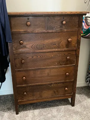 Antique dark-stained pine tallboy dresser.