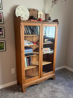 Antique oak bookcase featuring double glass doors.