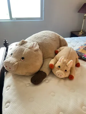 Two vintage plush pig stuffed animals.