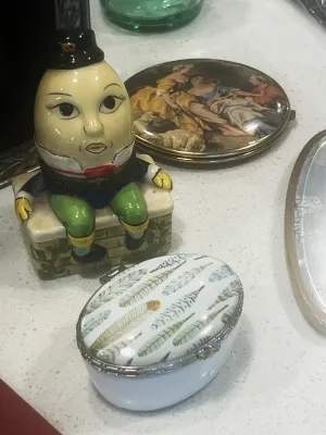 Vintage Humpty Dumpty ceramic figurine sitting on a wall