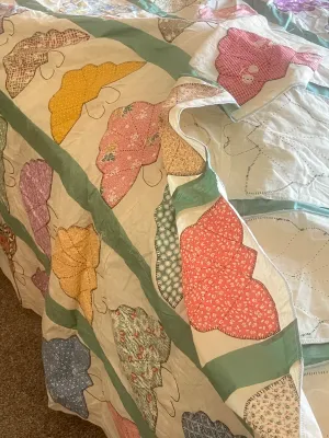 Vintage handmade quilt featuring colorful butterfly applique patches.