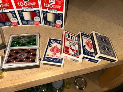 POKER CHIPS AND SEVERAL DECKS OF CARDS