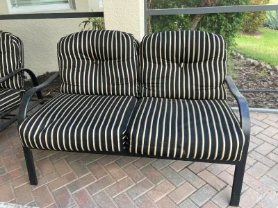 Patio Loveseat with Black Stripped Cushions