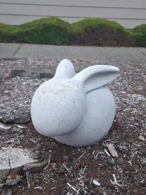 Minimalist concrete rabbit garden statue with a smooth, rounded form and stylized ears.