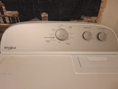 Whirlpool clothes dryer control panel, showing dials for automatic dry, temperature, and cycle signal settings.