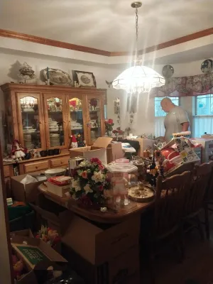 Traditional oak dining room set including a large china cabinet, dining table with chairs, and various decorative items, tableware, and...