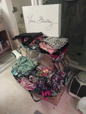 Large collection of Vera Bradley quilted cotton bags, purses, and accessories in various colorful patterns, displayed with a Vera Bradley...