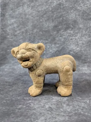 Pre-Columbian style terracotta animal effigy figure, possibly representing a jaguar or dog, featuring a textured clay finish and carved...