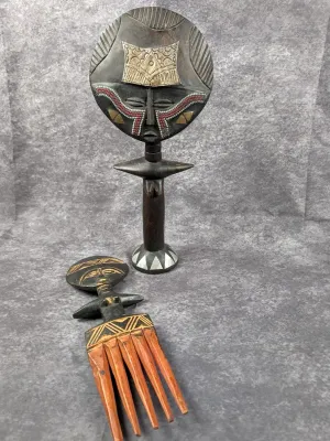 African Ashanti Akua'ba fertility doll with beaded and metal accents, paired with a carved wooden comb featuring a matching stylized...