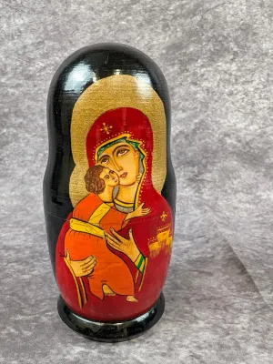 Hand-painted Russian nesting doll featuring a religious icon depiction of the Madonna and Child, finished in a glossy lacquer.