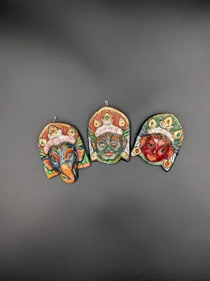 Set of three hand-painted wooden Hindu deity wall plaques depicting Ganesha, Shiva, and Parvati.