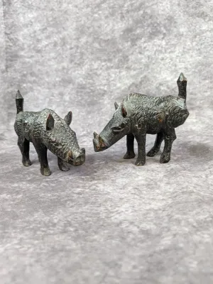 Pair of vintage hand-carved wooden wild boar figurines, featuring detailed textured fur and tusks.