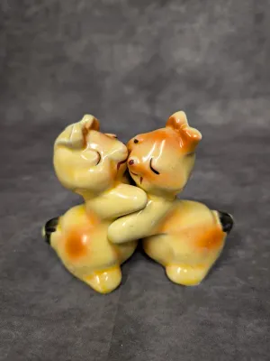 Vintage ceramic hugging bears figurine, featuring a yellow and orange glazed finish with hand-painted details.